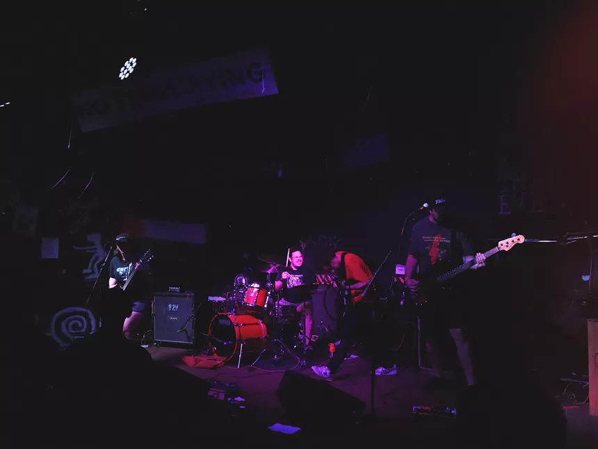 A band playing on stage at the venue 924 Gilman.