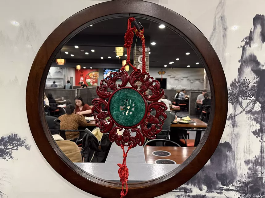 mirror with a dining room in the reflection