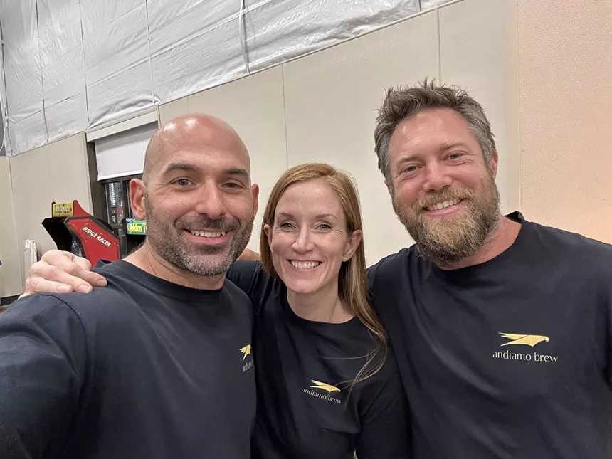 Three human beings in dark shirts.