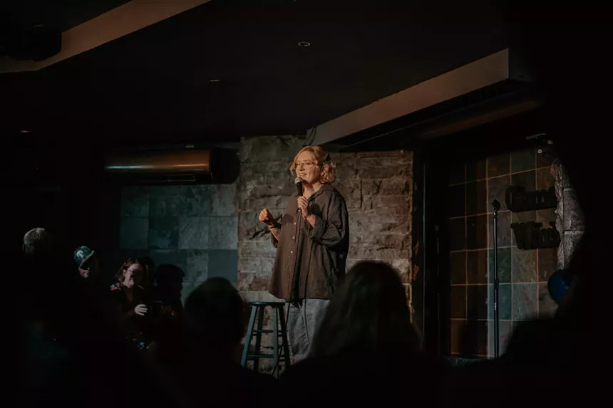 A woman performs onstage.