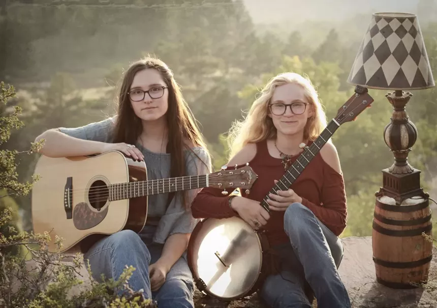 a woman with a banjo and a woman with a guitar