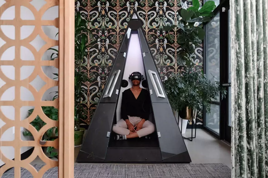 person in a pyramid-shaped pod