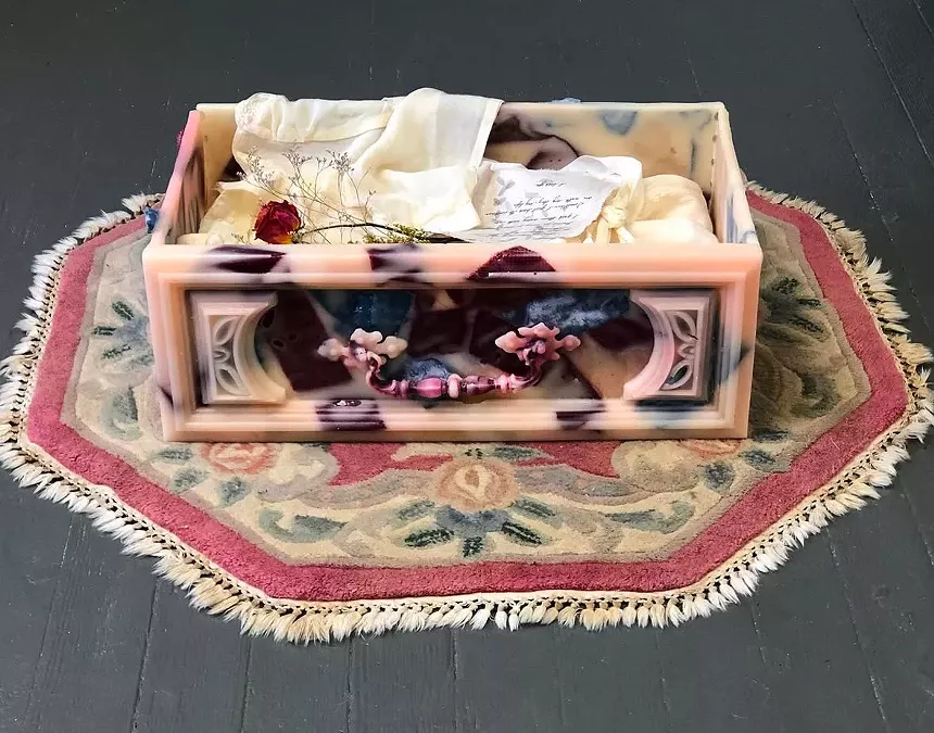 A beeswax drawer on a small ornate rug