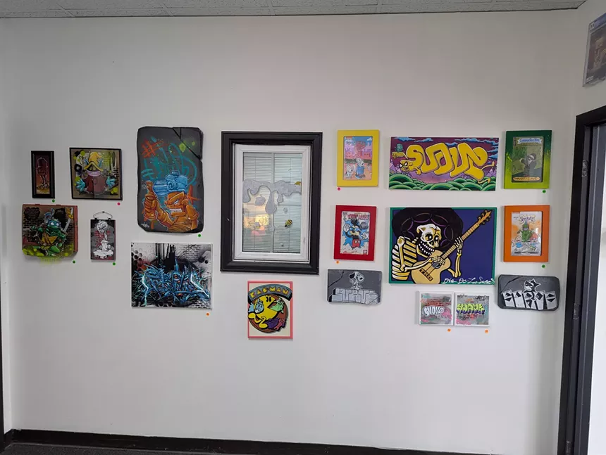 A wall of hanging art