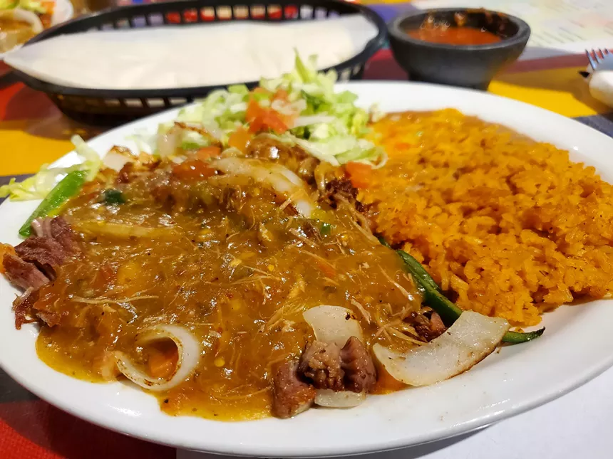 carnitas and rice on a plate