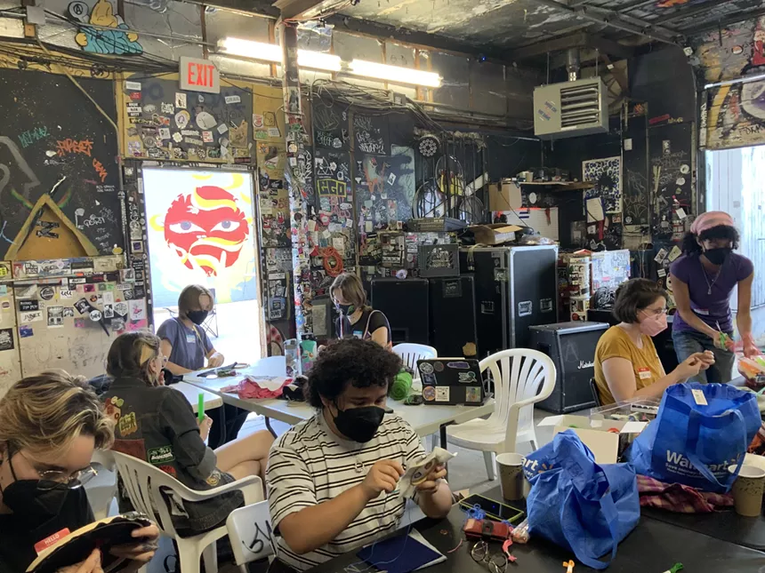 People gather in a black room