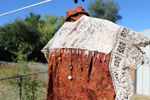 A shirt with a lace and bead collar