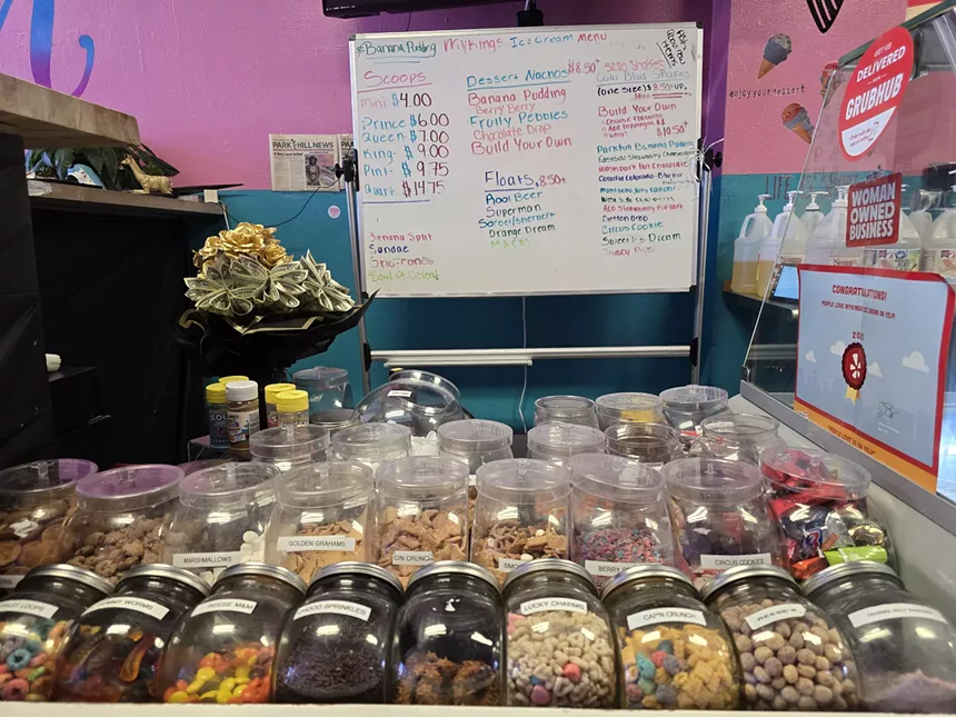 variety of cereals and candies in jars on a counter