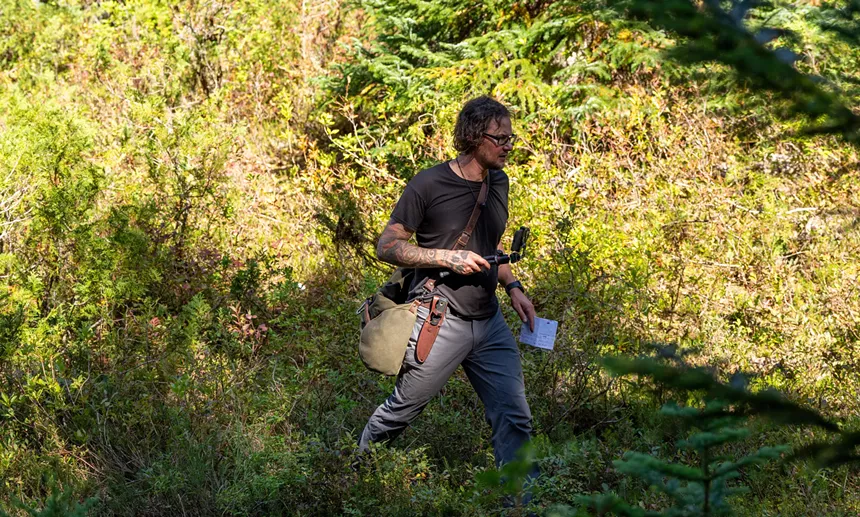 Willis trekking through thick vegetation