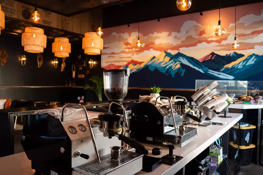 interior of a coffee shop with a mountain mural