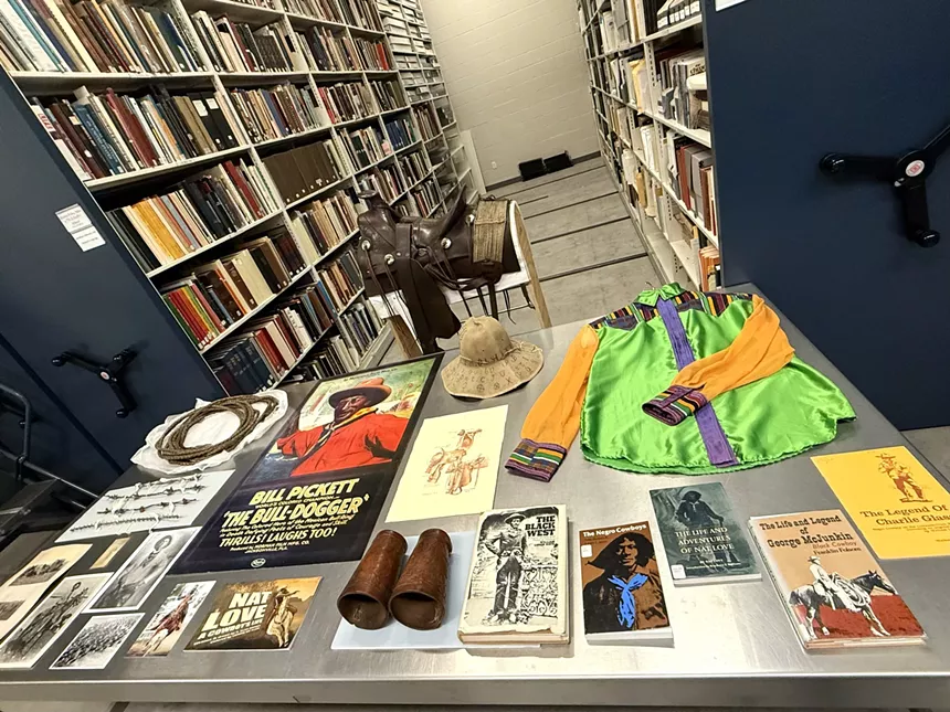 A table of books, photos and clothes