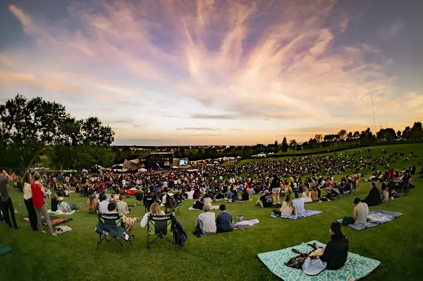 people picnicking at an outdoor venue in the summer