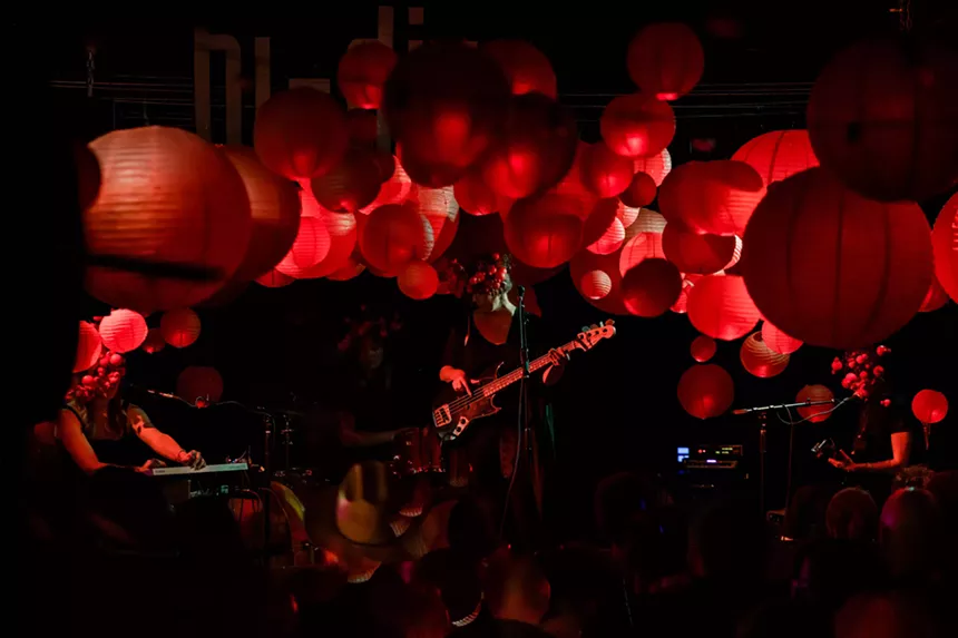A band plays against a backdrop of red lanterns.