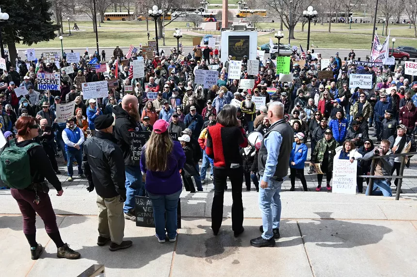 A state lawmaker speaks to protesters.
