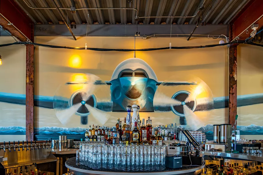 a bar with a mural of an airplane