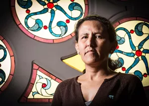 woman in front of stained glass.