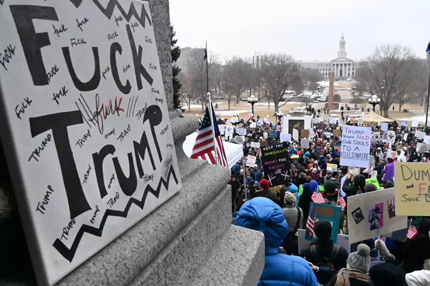 A sign reads "Fuck Trump"