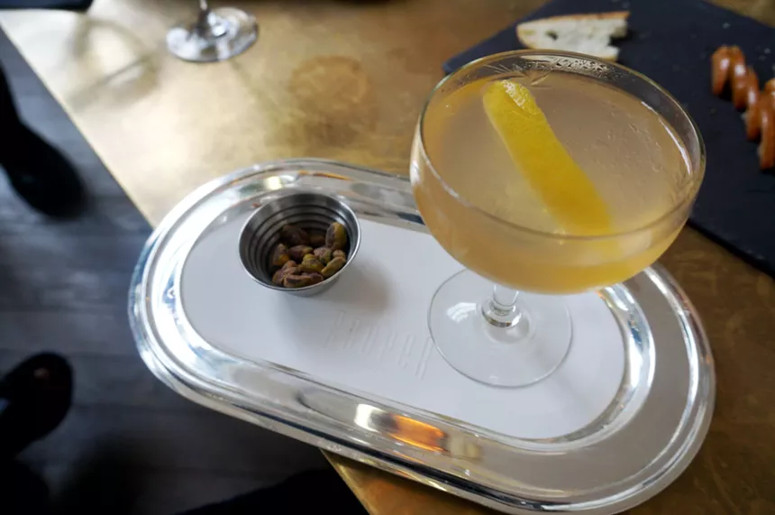 A cocktail and nuts