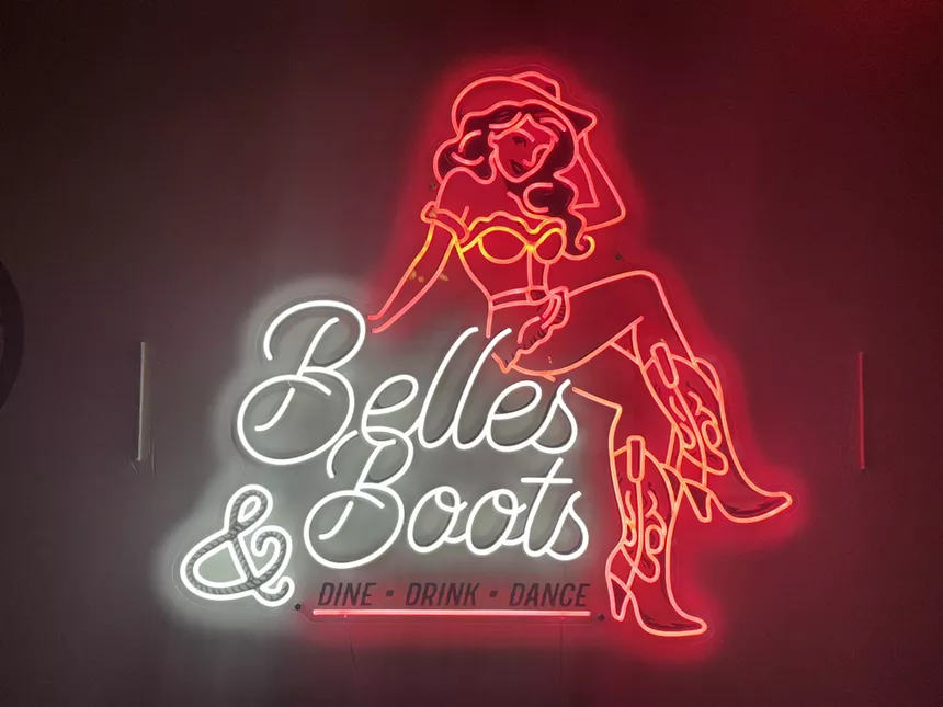 neon "belles & boots" sign