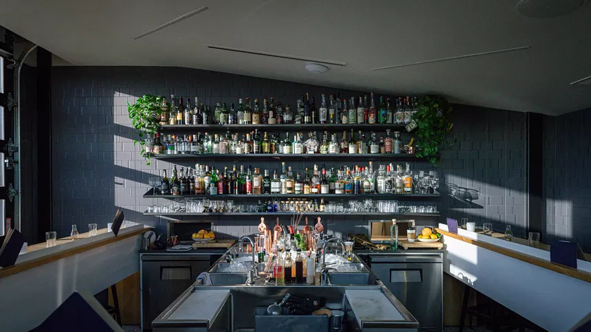 A bar with shelves of drinks