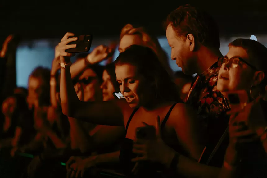 A photo of a concertgoer dancing.