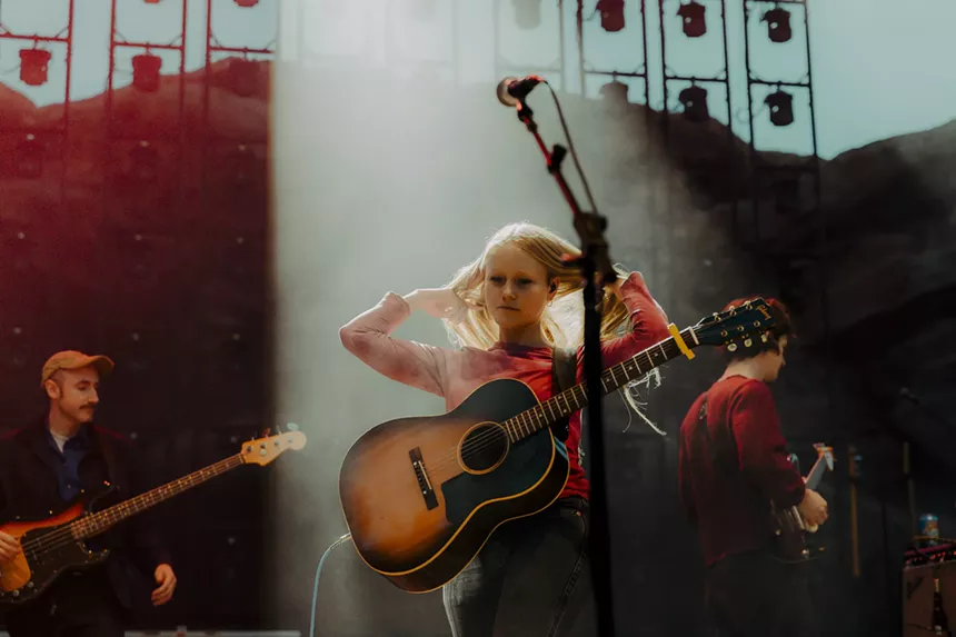 A picture of Alice Phoebe Lou fixing her hair during her Red Rocks performance.