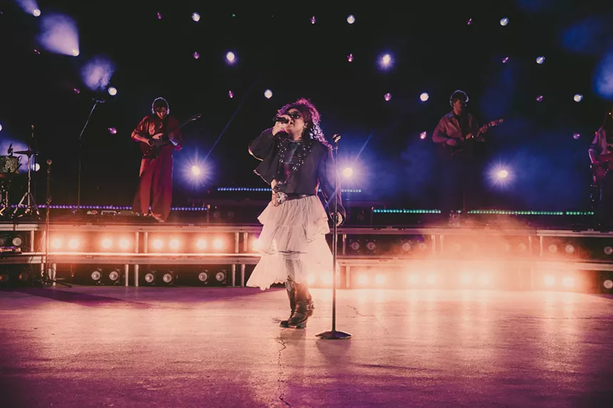 Remi Wolf singing on stage at Red Rocks.