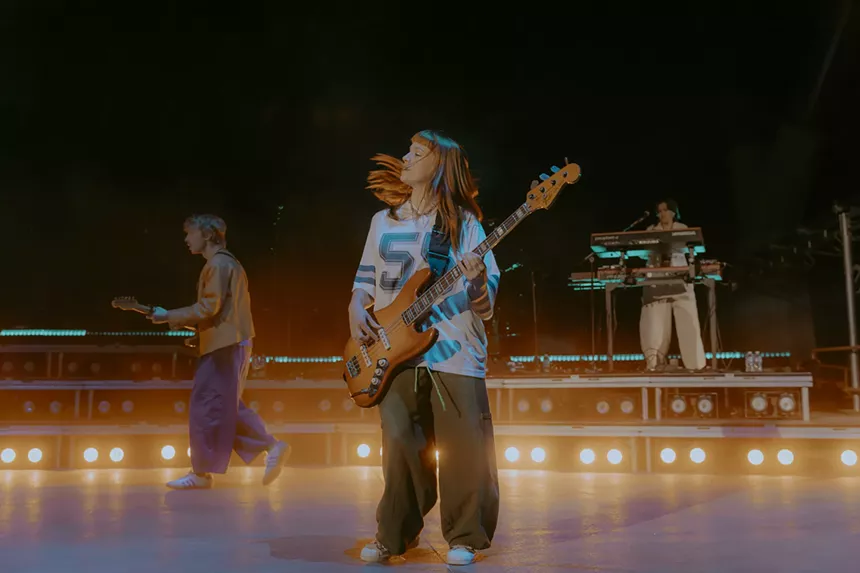 A photo of a bass player on stage at Red Rocks.