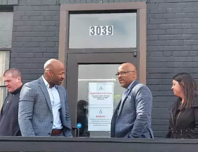 People greet each other in front of door