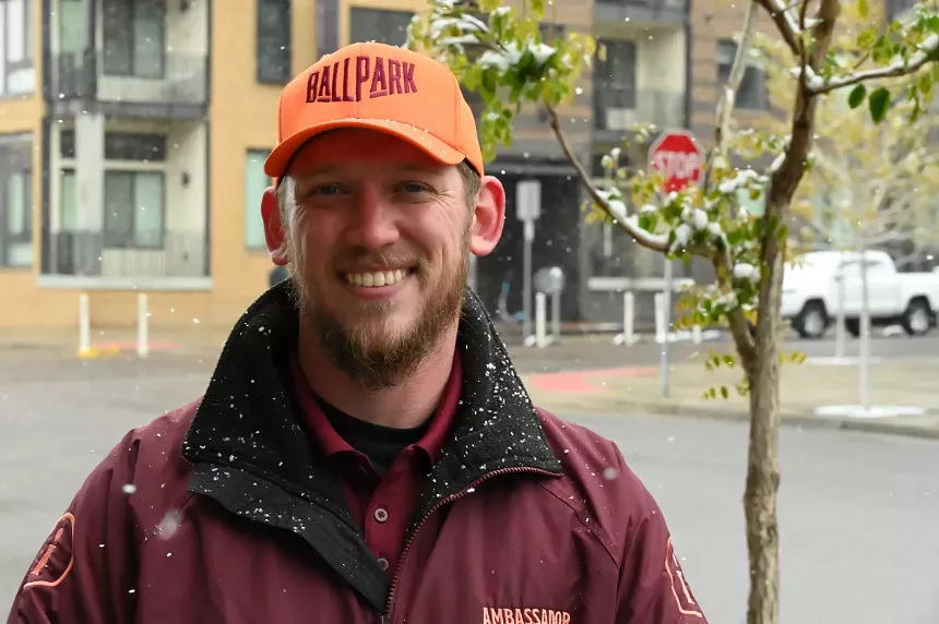 A man smiles in the snow.