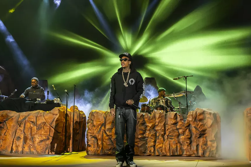 Wiz Khalifa on stage at Red Rocks with his stage design behind him.