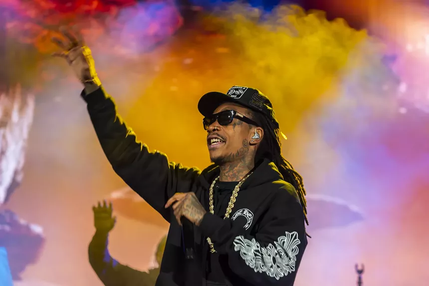 Wiz Khalifa smiling at the crowd.