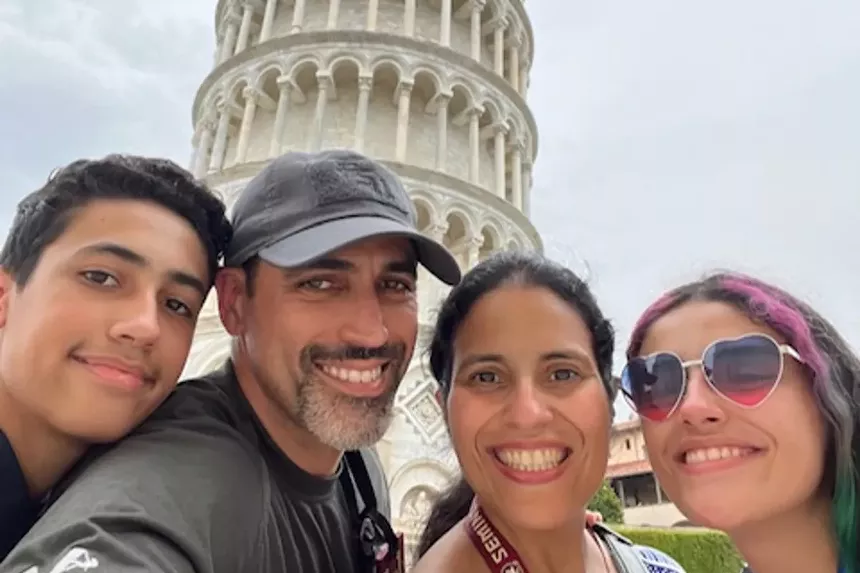 A family in front of the Leaning Tower of Pisa.