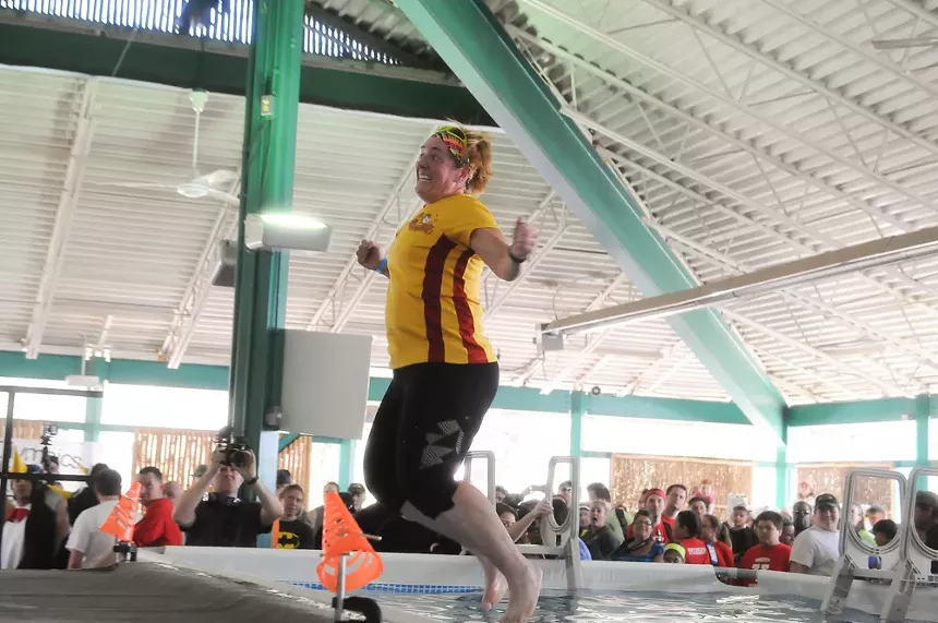 A person jumping into a pool