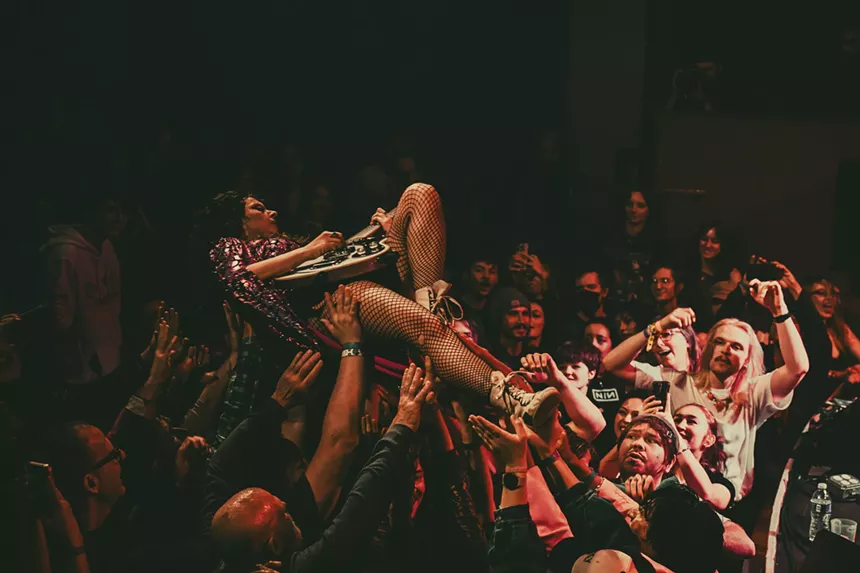 A photo showing Demi Demitro, of The Velveteers, crowd-surfing.