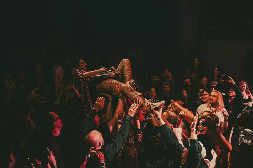 A photo showing Demi Demitro, of The Velveteers, crowd-surfing.