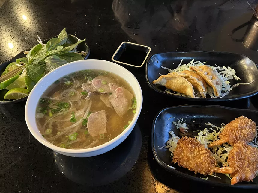 bowls of pho and other appetizers.