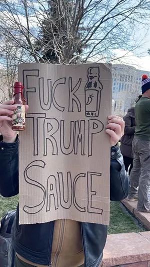 protest sign with hot sauce