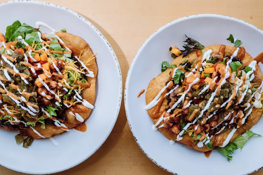 Two of Tocabe's fry bread tacos topped with Native ingredients