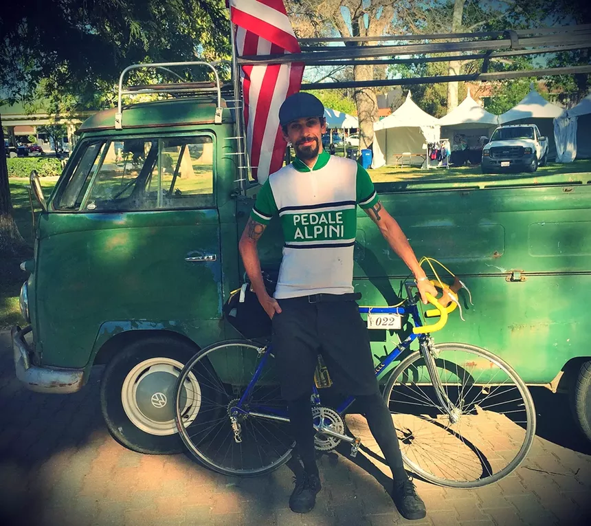 A man with a green bike