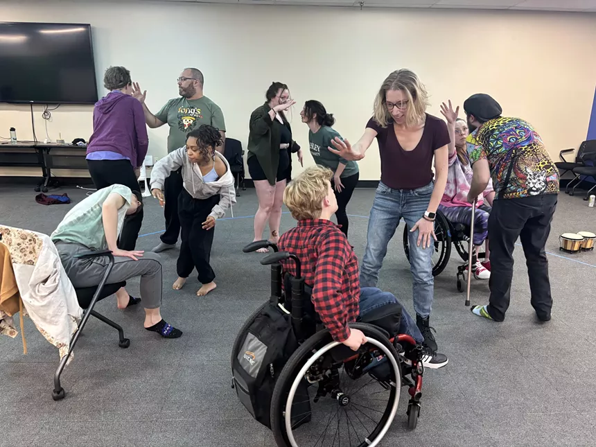Artists with disabilities practice a play.