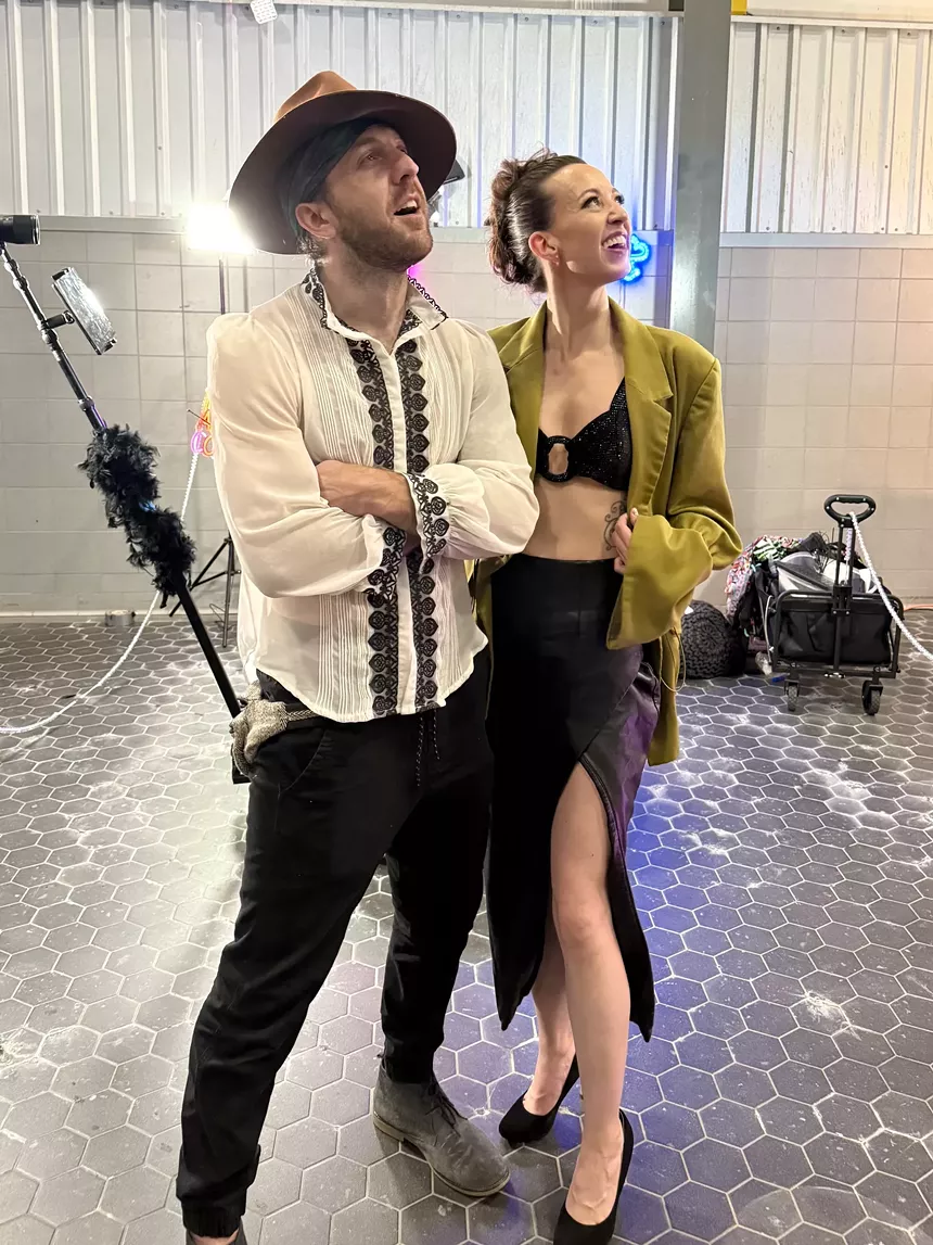 A man and a woman strike a pose