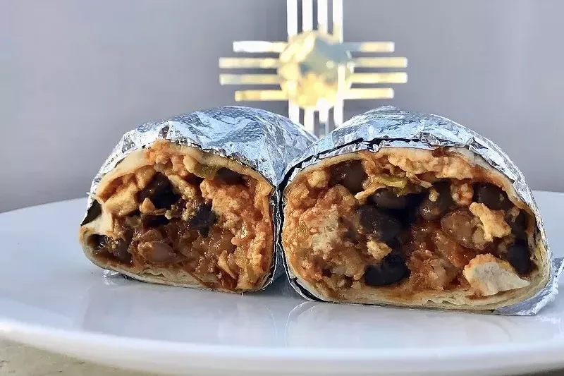 A breakfast burrito from Santo, split in half and wrapped in foil