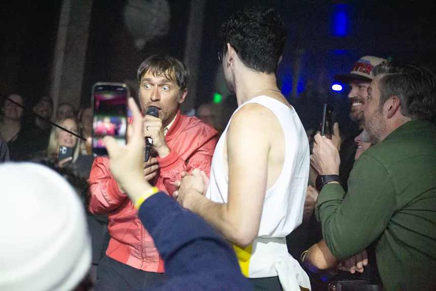 A vocalist sings from out in the audience