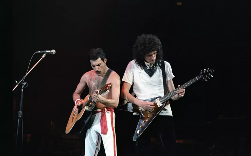 Freddie Mercury and Brian May playing guitar