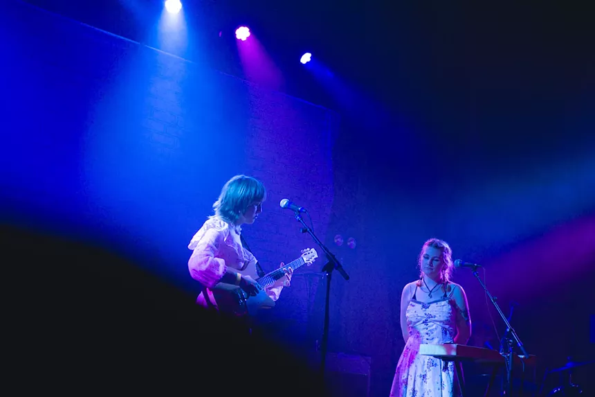 Band members perform on a stage