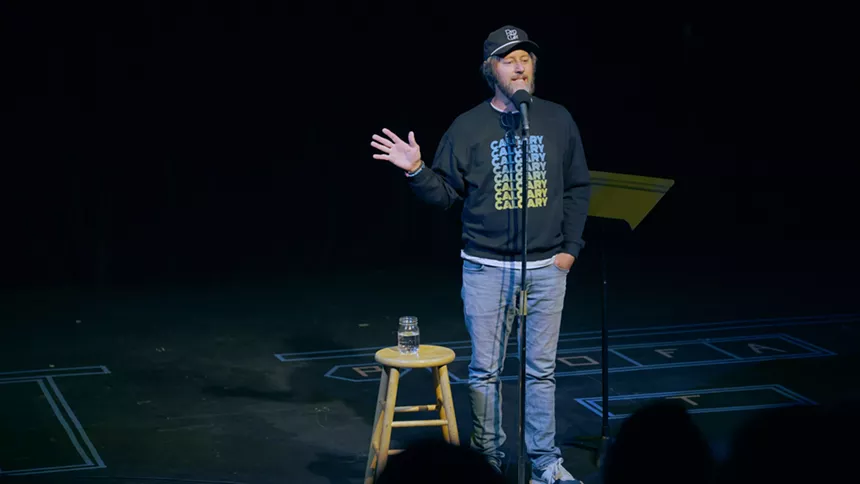 A man talks into a microphone.
