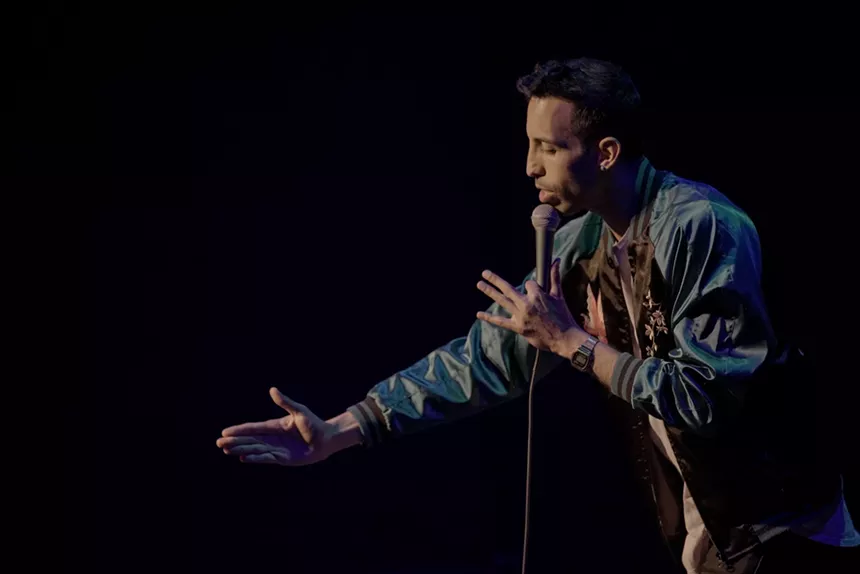 A man talks into a microphone.