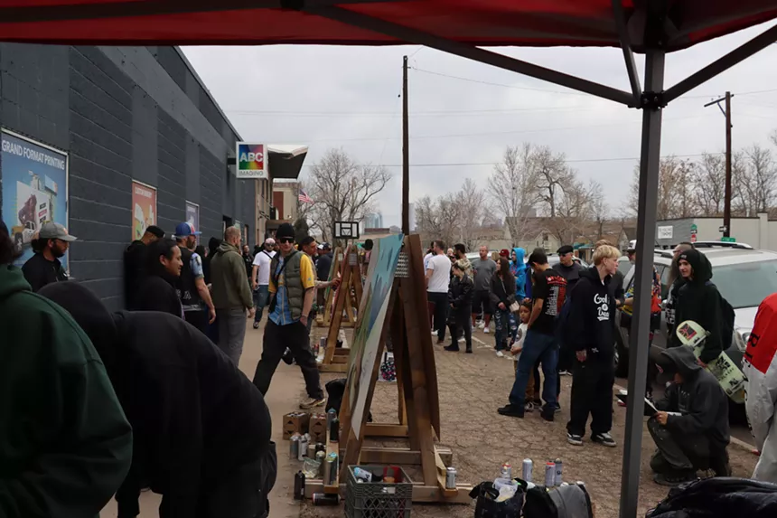graffiti artists painting on canvases