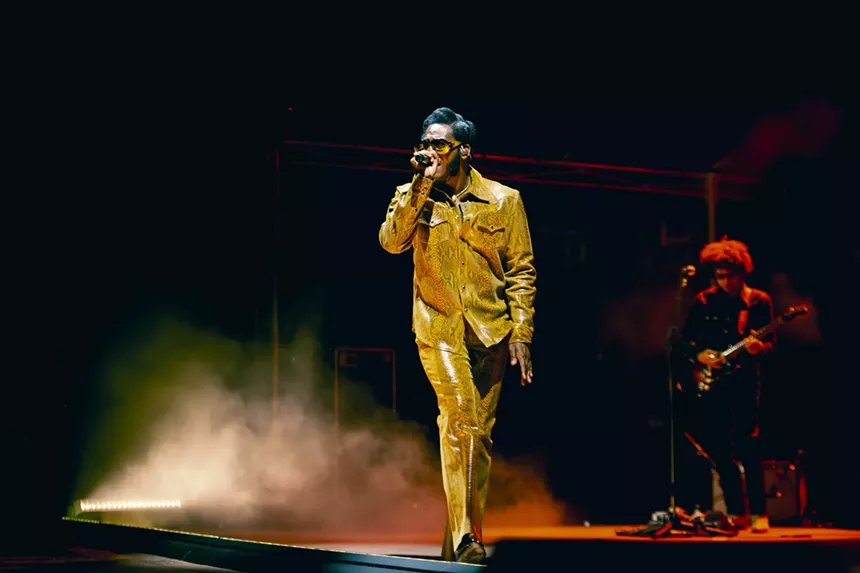 Leon Bridges on stage at Red Rocks with a fog behind him.